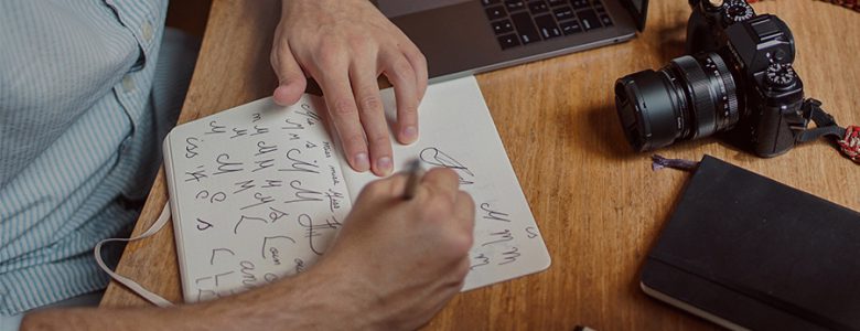 A man drawing images on a paper